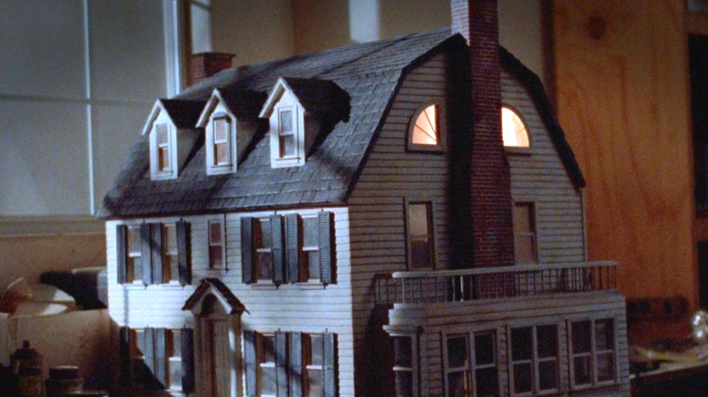 The Amityville dollhouse glowing from the inside