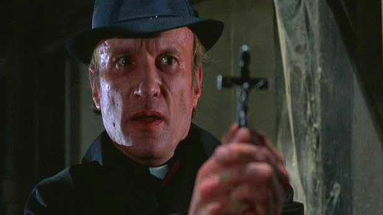 A priest exorcising the house