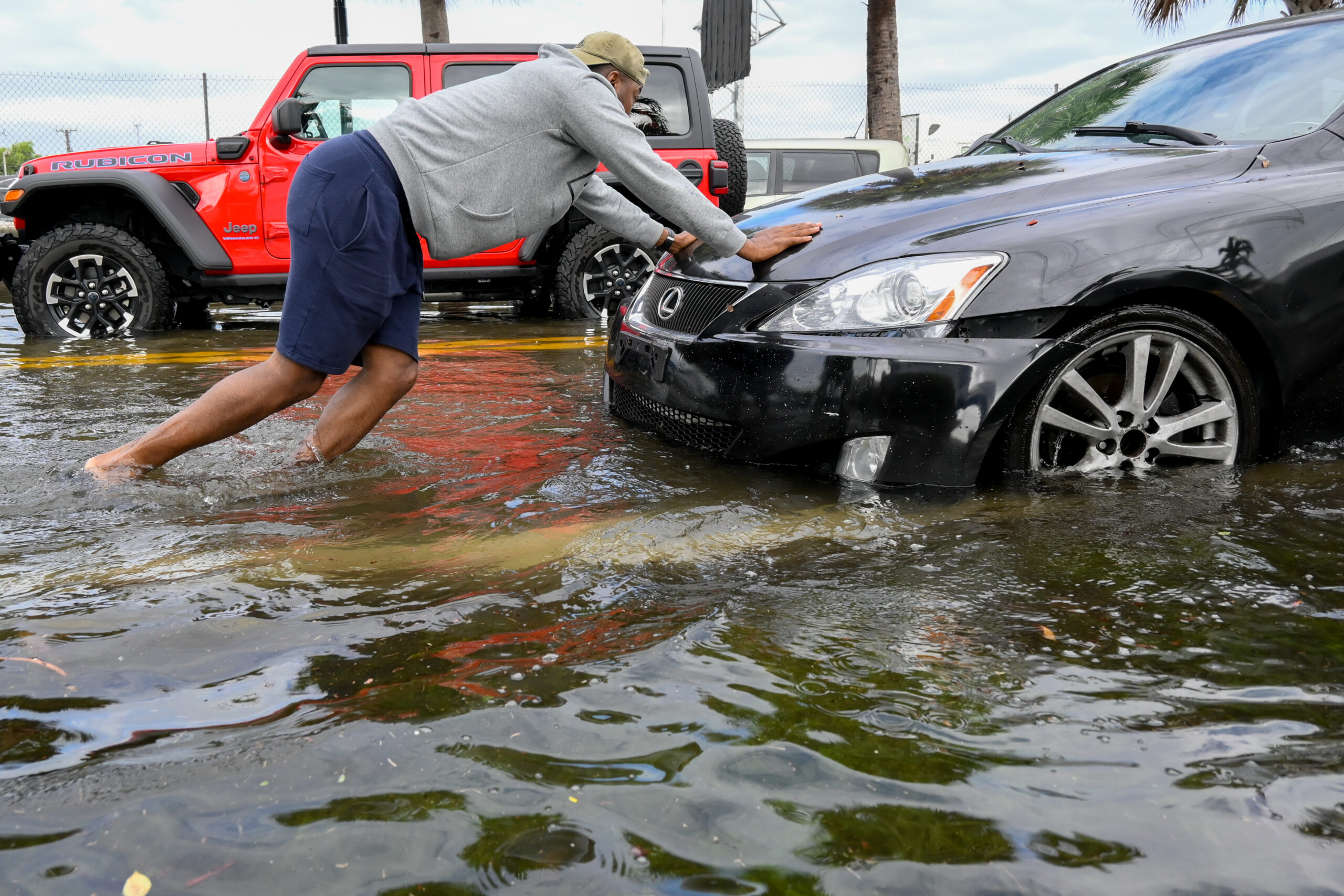 One man was shown trying to move his car in the midst of the rainstorm