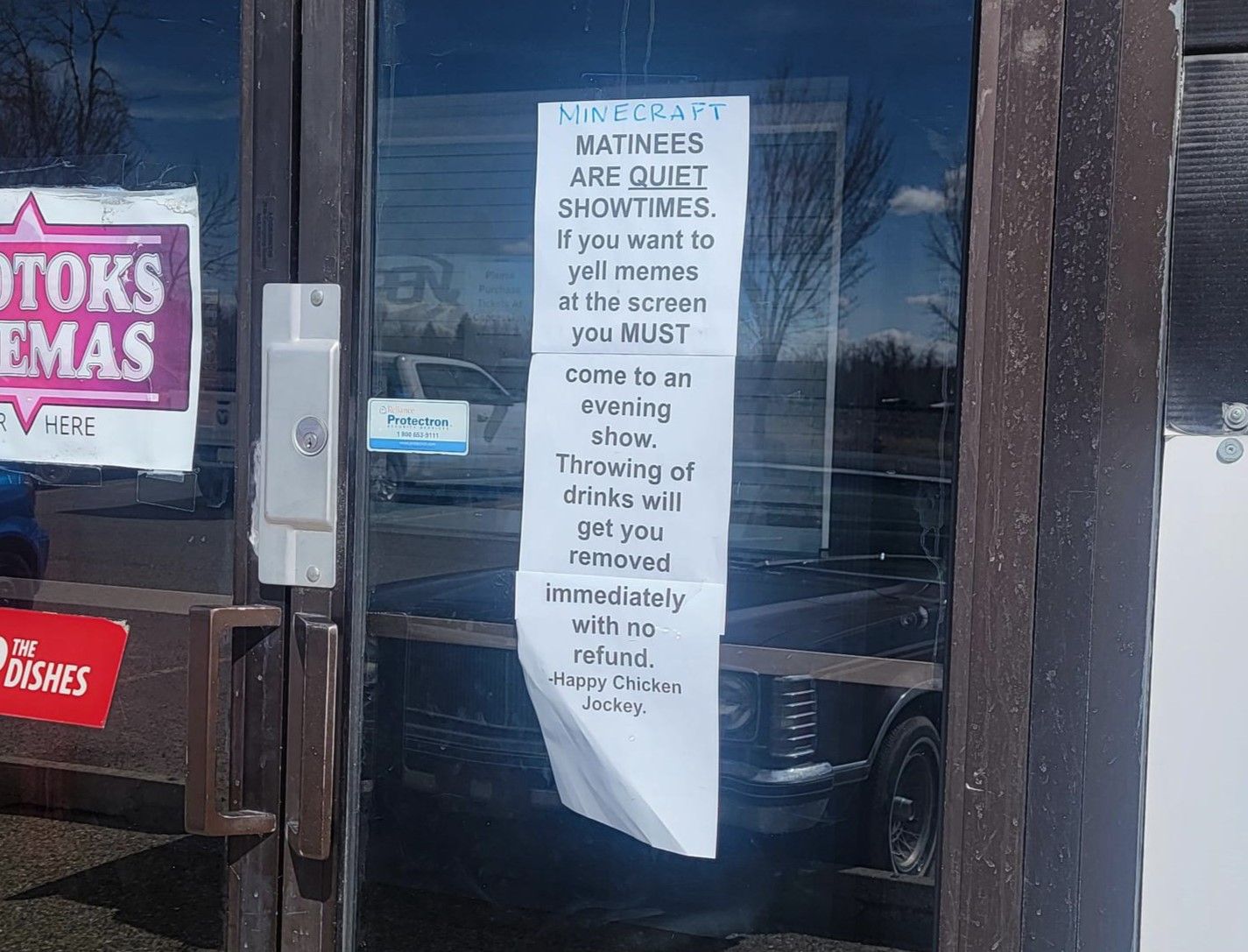 A sign at the entrance of Okotoks Cinemas advising people of the new rules.