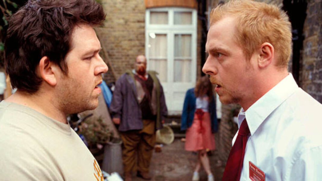 - Zombie Gaming Shaun and Ed staring at each other in front of zombies in Shaun of the Dead