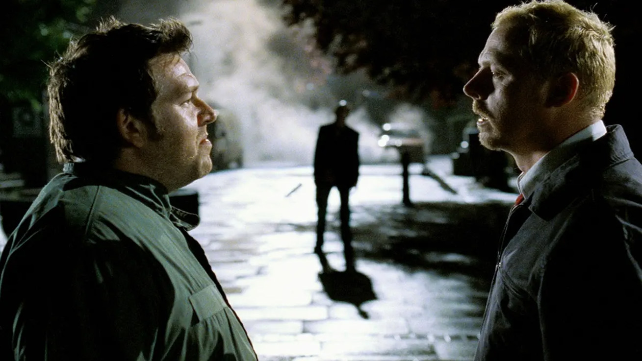 - Zombie Gaming Shaun and Ed Staring at Each other with a Zombie in the background