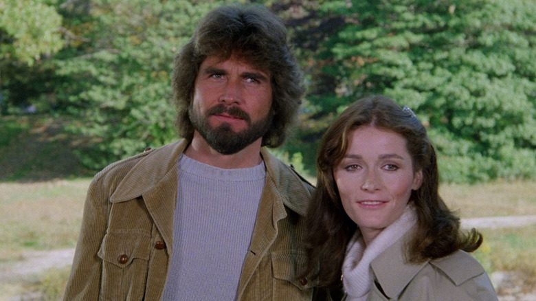 George and Kathy Lutz standing in the garden of the Amityville house